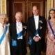 Queen Camilla, King Charles III, Prince William, Prince of Wales and Catherine, Princess of Wales pose for a photograph ahead of The Diplomatic Reception in the 1844 Room at Buckingham Palace on December 05, 2023 in London, England.
